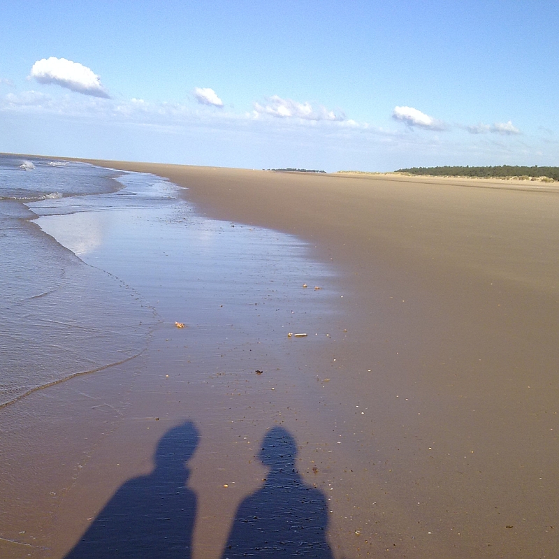 Shadows of two people on Holkham Beach Norfolk by Xtrahead photography